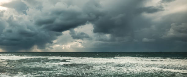 istock Dramatic sky and rough sea at sunset 1386498445