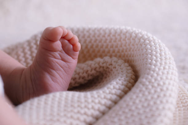 istock New Born Baby Feet on White Blanket 1386500982