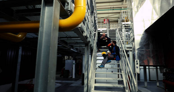 istock After a hard work shift, the heating plant workers sit on the steps and rest during lunch. 1386501836
