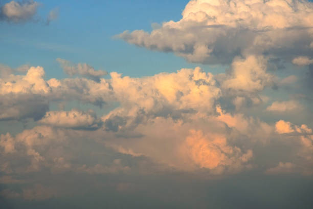 istock Sky with cumulus clouds at sunset. Big air clouds, illuminated by sunlight. 1386502203
