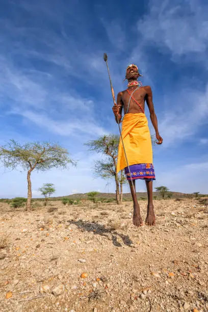 Photo of Warrior from Samburu tribe performing traditional jumping dance, Kenya, Africa