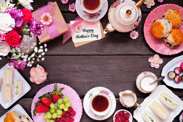 istock Mother's Day tea frame over a dark wood banner background 1386504167