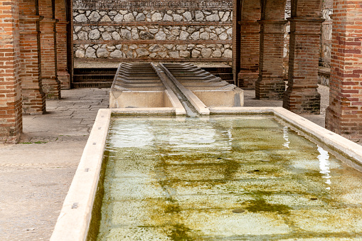 Aracena, Spain - 16 March, 2022: historic public laundry installation and fountain in the city center of Aracena