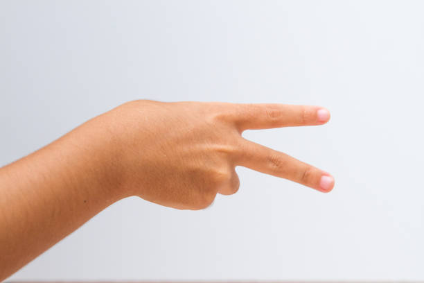 child making number 2 sign on a white background in Rio de Janeiro.