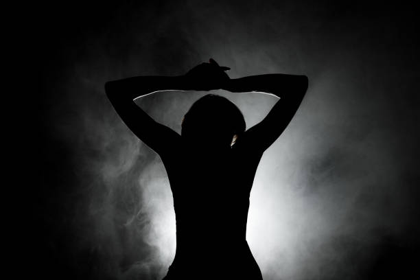 istock silhouette modern ballet dancer posing on dark background with smoke 1386507683