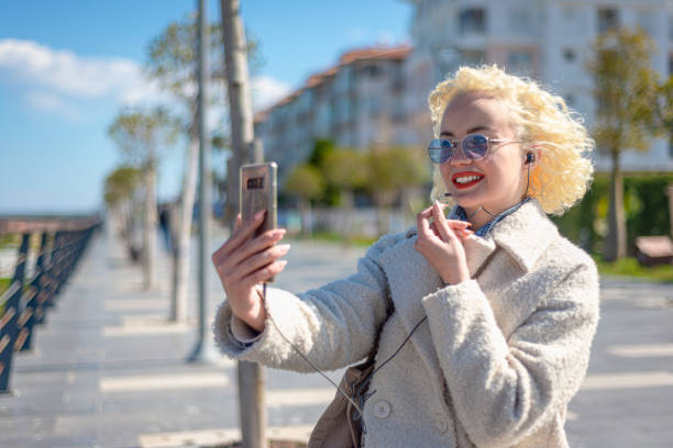 istock Young woman on a vacation vlogging 1386512510