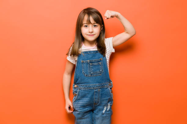 istock Strong little girl showing her arms 1386514633