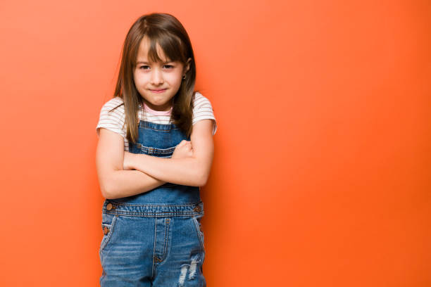 istock Upset little girl frowning in a studio 1386514638