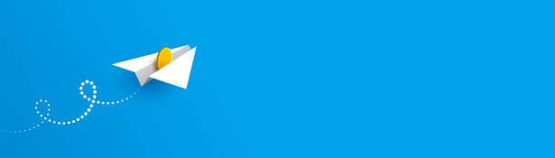 istock Horizontal banner with paper plane and gold coin over blue background 1386514848