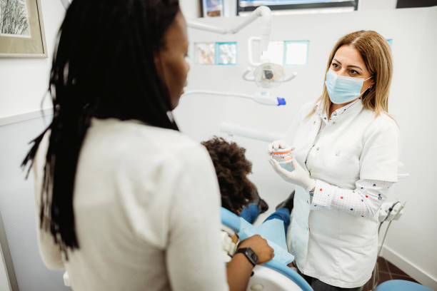 istock Young girl on dentist's chair. 1386515654