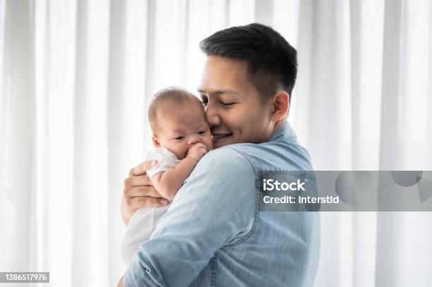 Father Holding Baby Daughter And Kissing Stock Photo - Download Image Now - Father, Newborn, Baby - Human Age