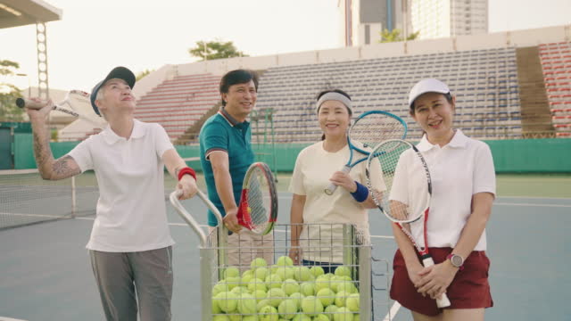 Portrait of seniors tennis game on tennis court