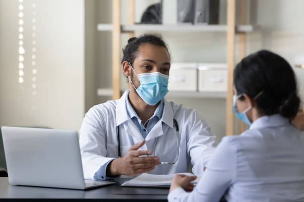 istock Happy diverse doctor and patient talking in office. 1386519193