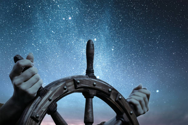 istock Steering hand wheel ship on sky background 1386522289