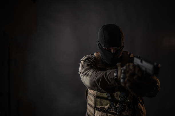 istock Male soldier with a handgun 1386522546