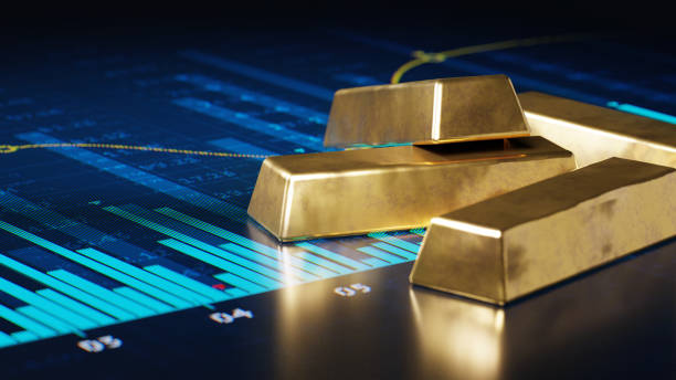 Bars  of gold on digital display with abstract financial graphs.