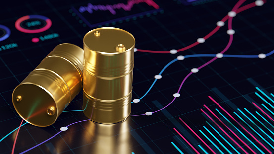 Oil/fuel crisis concept image. Two golden oil barrels on the digital display with abstract financial graphs.