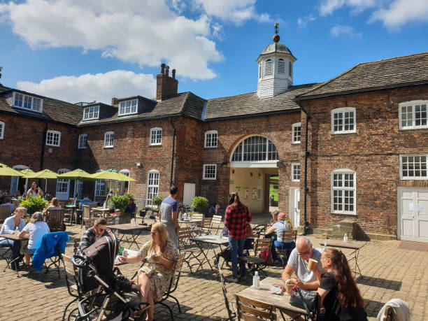 People enjoy their drinks at a cafe in Temple Newsam Park in West Yorkshire on a beautiful summer day Yorkshire, United Kingdom - August 23, 2021: People enjoy their drinks at a cafe in Temple Newsam Park in West Yorkshire on a beautiful summer day temple newsam stock pictures, royalty-free photos & images