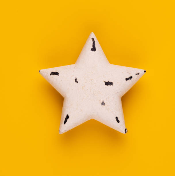 istock Christmas star decor on yellow colored background. 1386527941