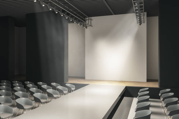 istock Modern concrete auditorium interior with seats, runway and blank mock up place on wall. Presentation and fashion concept. 3D Rendering. 1386528035
