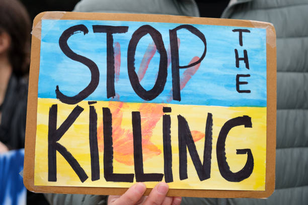 istock stop the killing sign with Ukranian flag colors 1386529259