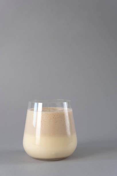 istock Glass of traditional Indian mango lassi drink on a grey background. Vertical background 1386529343