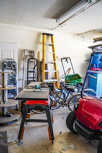 An over-crowded unorganized garage. Vertical.