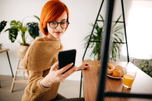 istock Woman texting her friends at the breakfast table 1386529940