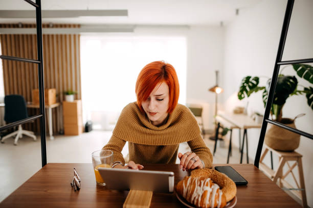 istock Woman has breakfast and works on the tablet 1386529980