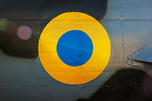 Yellow blue circle ukraine flag armed forces on camouflage background.