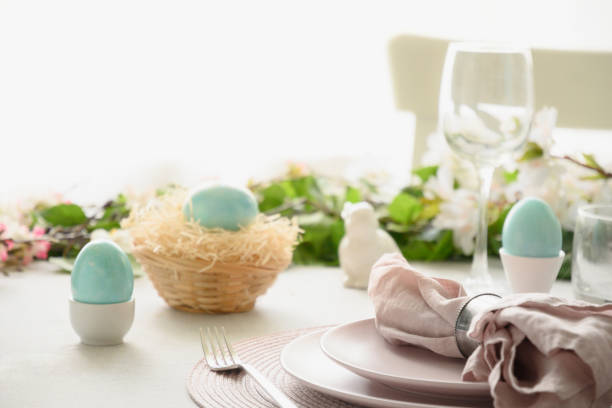 istock Easter table setting with yellow chick,decorations, fresh flowers and eggs. Elegance dinner at home. 1386534900