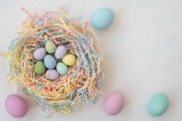 istock View from above. Nest with colorful Easter eggs. There is space for text. Pastel shades. Small quail eggs and large chicken eggs 1386536732