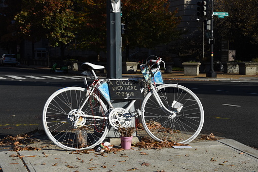 A ghost bicycle leans against a lamp post along Constitution Avenue to mark the spot where a cyclist was hit and killed by a car.