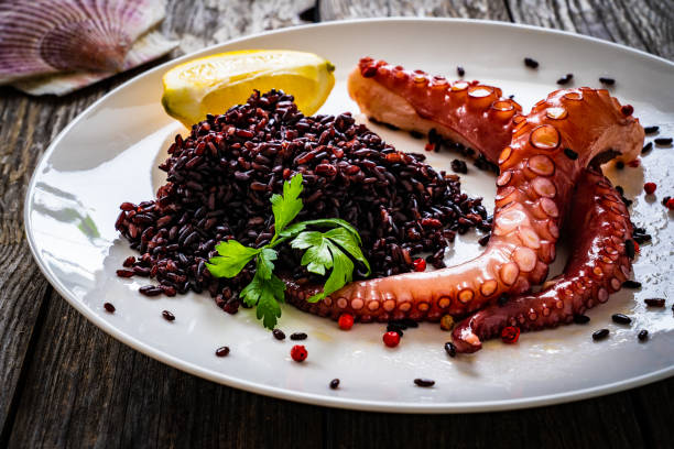 istock Boiled octopus and vegetables on wooden table 1386536828