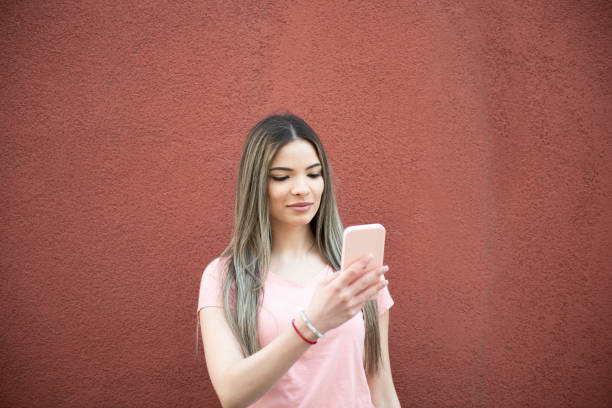 istock Young woman uses a smartphone 1386536936