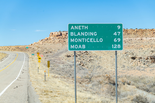 Utah highway information sign in green with distances to four towns ahead. This is just inside the border of Utah and Colorado in southeastern Utah, in the United States of America (USA). John Morrison Photographer