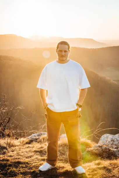 Photo of Cool Looking Young Man Outdoors at Sunset Millennial Generation Portrait