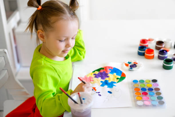 istock Profile of the cute child sitting at the table. 1386552071