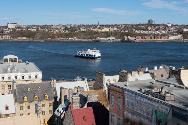 Quebec city, Quebec, Canada – 1 may 2021 : The ferry crossing the St Lawrence river between Levis and Quebec city, with the old Quebec city in foreground.
