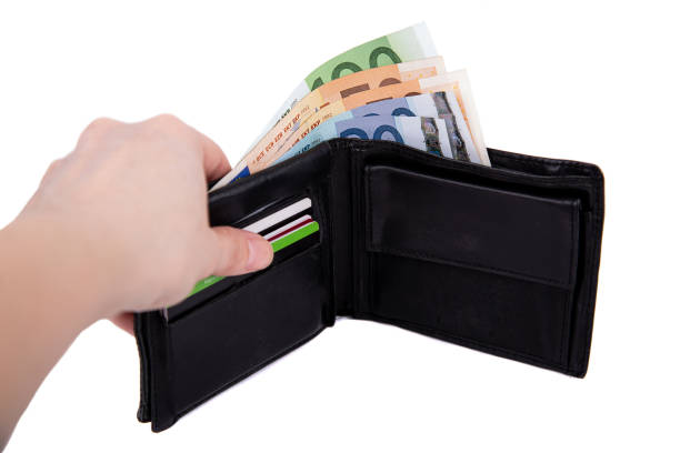 istock A man is holding an open wallet with money on a white background close-up 1386561705