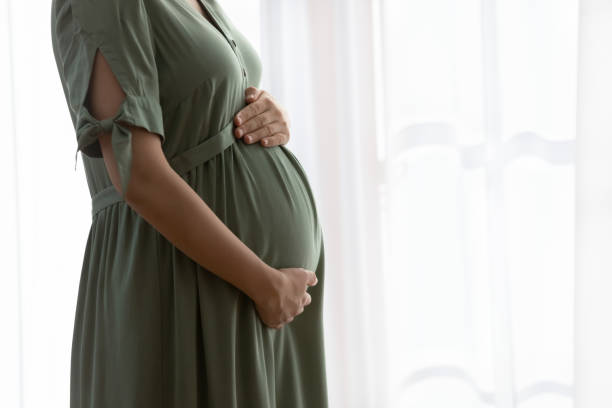 istock Caring future mom touch pregnant tummy feeling love 1386572051