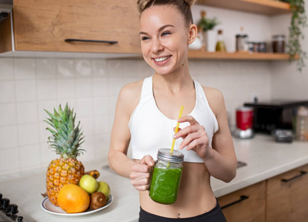 istock Optimistic sportswoman enjoying healthy drink 1386577949