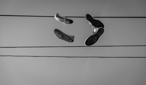 Shoes hanging from a telephone line.