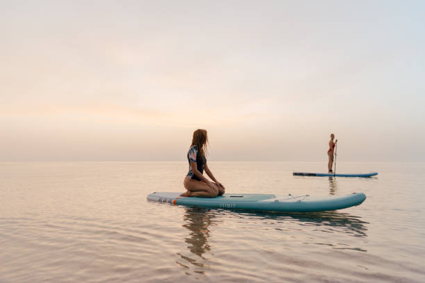 istock Girlfriends stand-up paddling together 1386580534