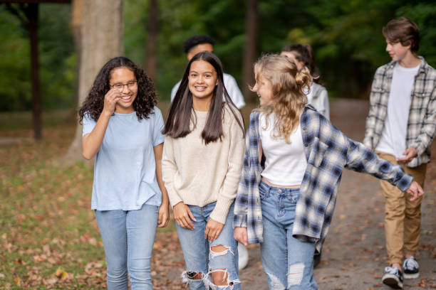 istock Teenagers Walking Outside Together 1386582013