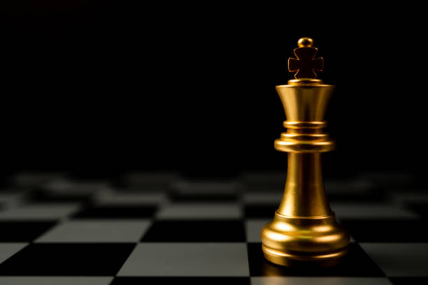 istock Golden Chess King standing alone on the chessboard 1386583046