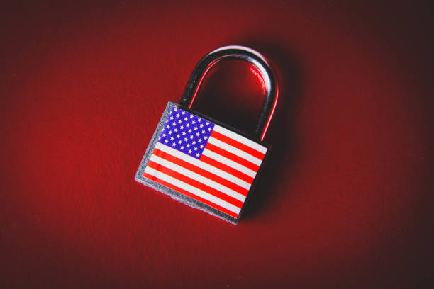 istock US sanctions. Closed padlock with USA flag. Supply ban. 1386587936