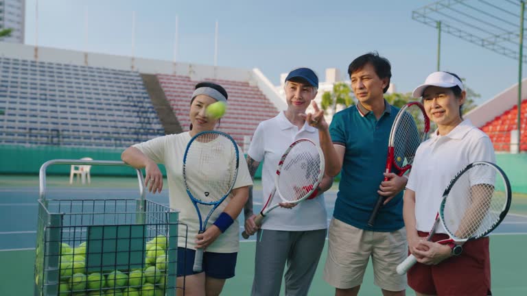 Portrait of seniors tennis game on tennis court