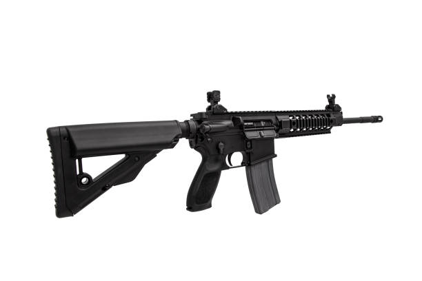 istock Modern automatic rifle isolated on black background. Weapons for police, special forces and the army. A carbine with optical, mechanical sights and a silencer on a dark background. 1386590365