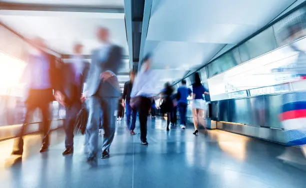 Business people rushing in the lobby.